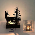 Portavelas de metal con forma de esqueleto con vela